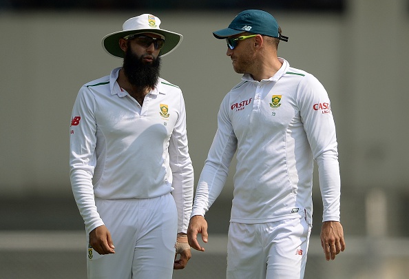 South Africa's Hashim Amla (L) speaks with teammate Faf du Plessis during the first day of a two day cricket match between the Indian Board President's XI and South Africa at The Brabourne Stadium in Mumbai on October 30, 2015. AFP PHOTO/ PUNIT PARANJPE ---- IMAGE RESTRICTED TO EDITORIAL USE - STRICTLY NO COMMERCIAL USE ---- (Photo credit should read PUNIT PARANJPE/AFP/Getty Images)
