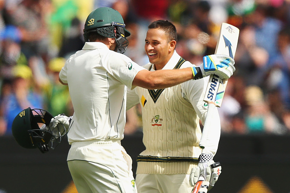 MELBOURNE, AUSTRALIA - DECEMBER 26: Usman Khawaja of Australia celebrates his century with Joe Burns (L) during day one of the Second Test match between Australia and the West Indies at Melbourne Cricket Ground on December 26, 2015 in Melbourne, Australia. (Photo by Michael Dodge/Getty Images)