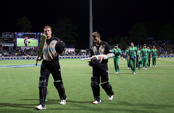 Martin Guptill (L) and Kane Williamson (C) of New Zealand leave the field following the second Twenty20 cricket match between New Zealand and Pakistan at Seddon Park in Hamilton on January 17, 2016.   AFP PHOTO / MICHAEL BRADLEY / AFP / MICHAEL BRADLEY        (Photo credit should read MICHAEL BRADLEY/AFP/Getty Images)