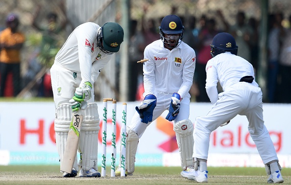 Australian cricketer Usman Khawaja (L) is dismissed by Sri Lankan bowler Dilruwan Perera as wicketkeeper Dinesh Chandimal (C) and fielder Kaushal Silva (R) look on during the second day of the second Test cricket match between Sri Lanka and Australia at The Galle International Cricket Stadium in Galle on August 5, 2016. / AFP / ISHARA S.KODIKARA        (Photo credit should read ISHARA S.KODIKARA/AFP/Getty Images)