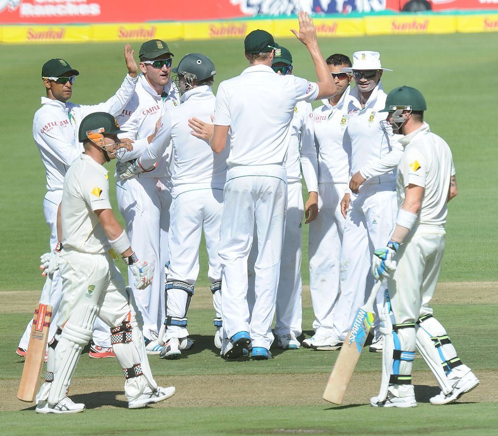 David Warner of Australia (L,foreground) leaves the wicket after being dismissed on day 1 of the third test match between South Africa and Australia at Newlands stadium in Cape Town on March 1, 2014. Heeger/AFP/Getty Images