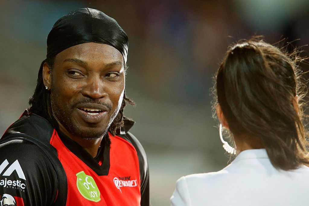 HOBART, AUSTRALIA - JANUARY 04:  Chris Gayle of the Melbourne Renegades gives a TV interview to Mel Mclaughlin during the Big Bash League match between the Hobart Hurricanes and the Melbourne Renegades at Blundstone Arena on January 4, 2016 in Hobart, Australia.  (Photo by Darrian Traynor/Getty Images)